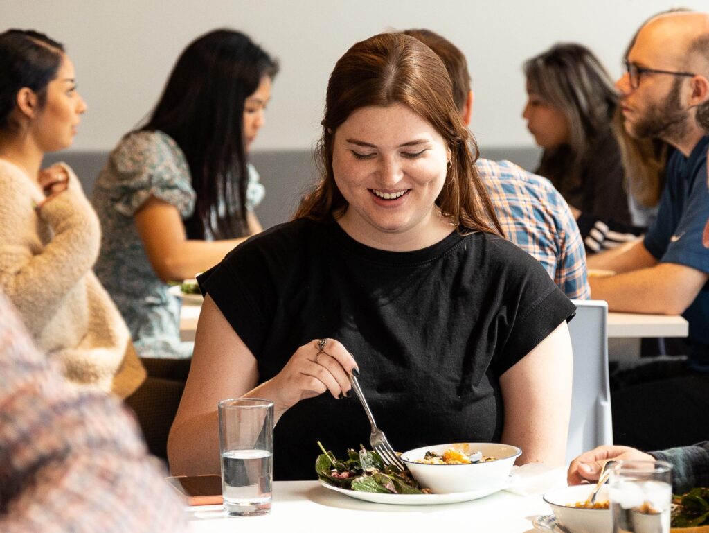 woman eating lunch and smiling